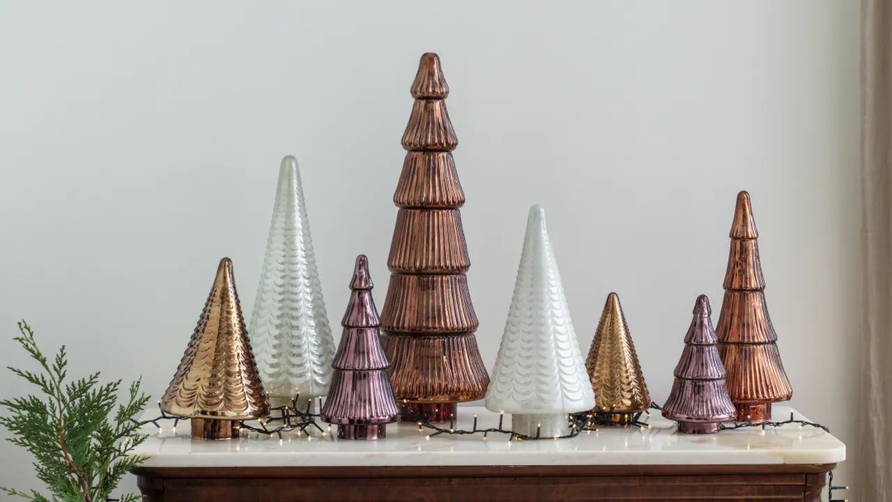 Two mint chocolate milkshakes with whipped cream and green sprinkles.