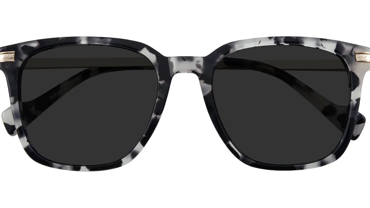 Two mint chocolate milkshakes with whipped cream and green sprinkles.