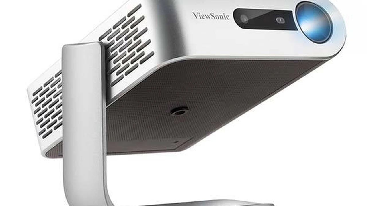 blue bowl of black bean beef tortilla soup on a board with cilantro and shredded cheese in background