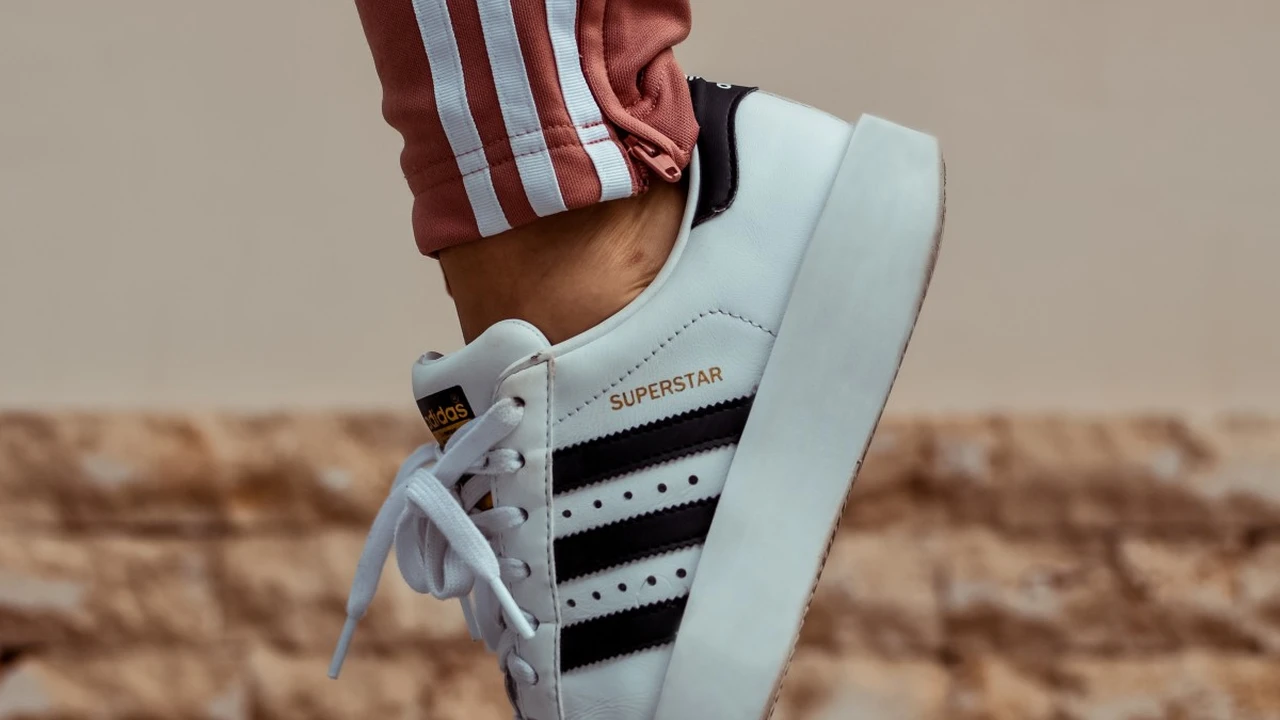 Two mint chocolate milkshakes with whipped cream and green sprinkles.