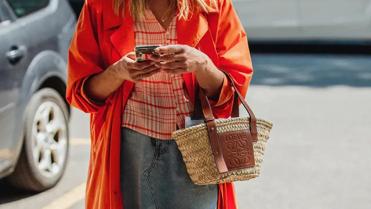 blue bowl of black bean beef tortilla soup on a board with cilantro and shredded cheese in background