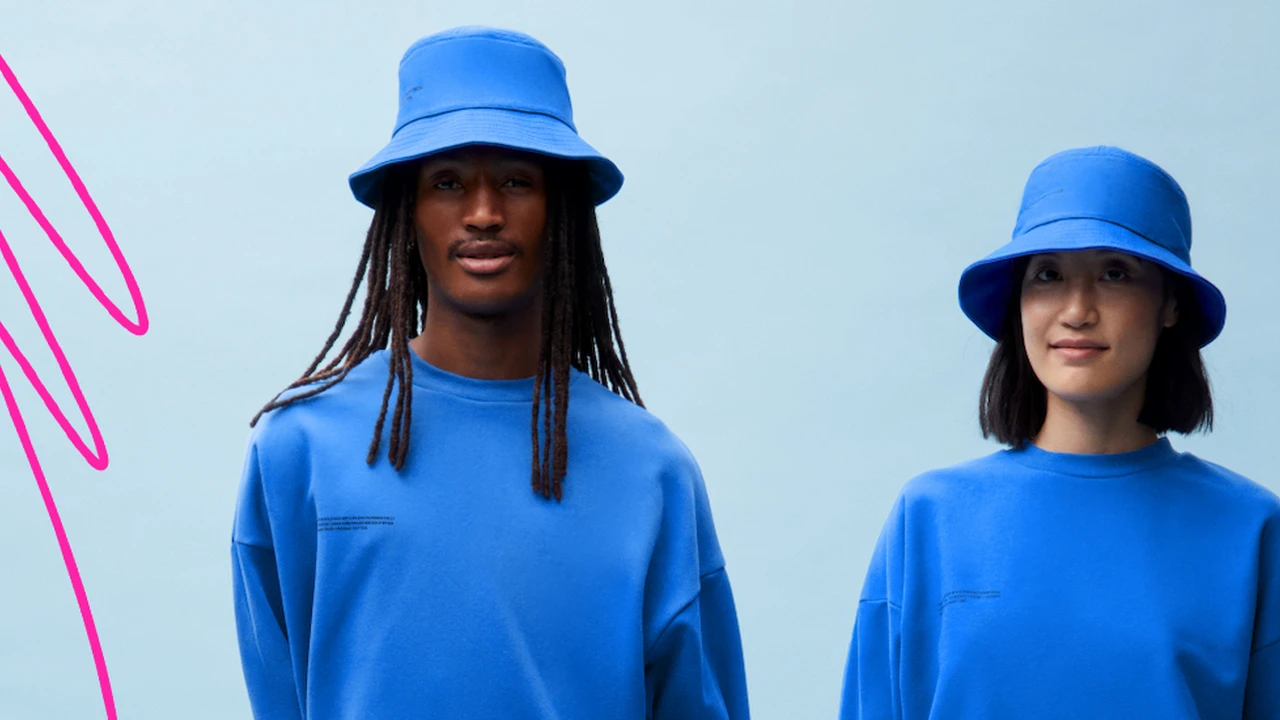 blue bowl of black bean beef tortilla soup on a board with cilantro and shredded cheese in background
