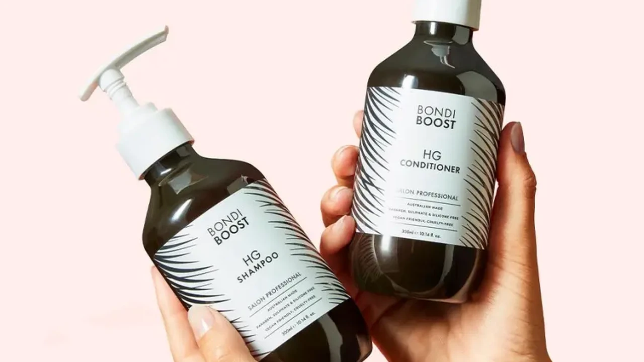 blue bowl of black bean beef tortilla soup on a board with cilantro and shredded cheese in background